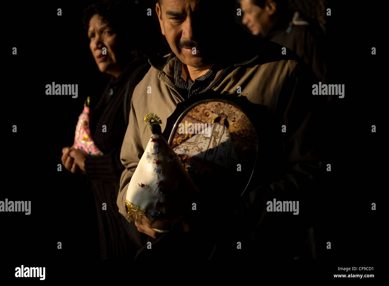 Un pèlerin comporte des images de Vierge de Juquila en dehors de la Basilique Notre Dame de Guadalupe à Mexico Banque D'Images