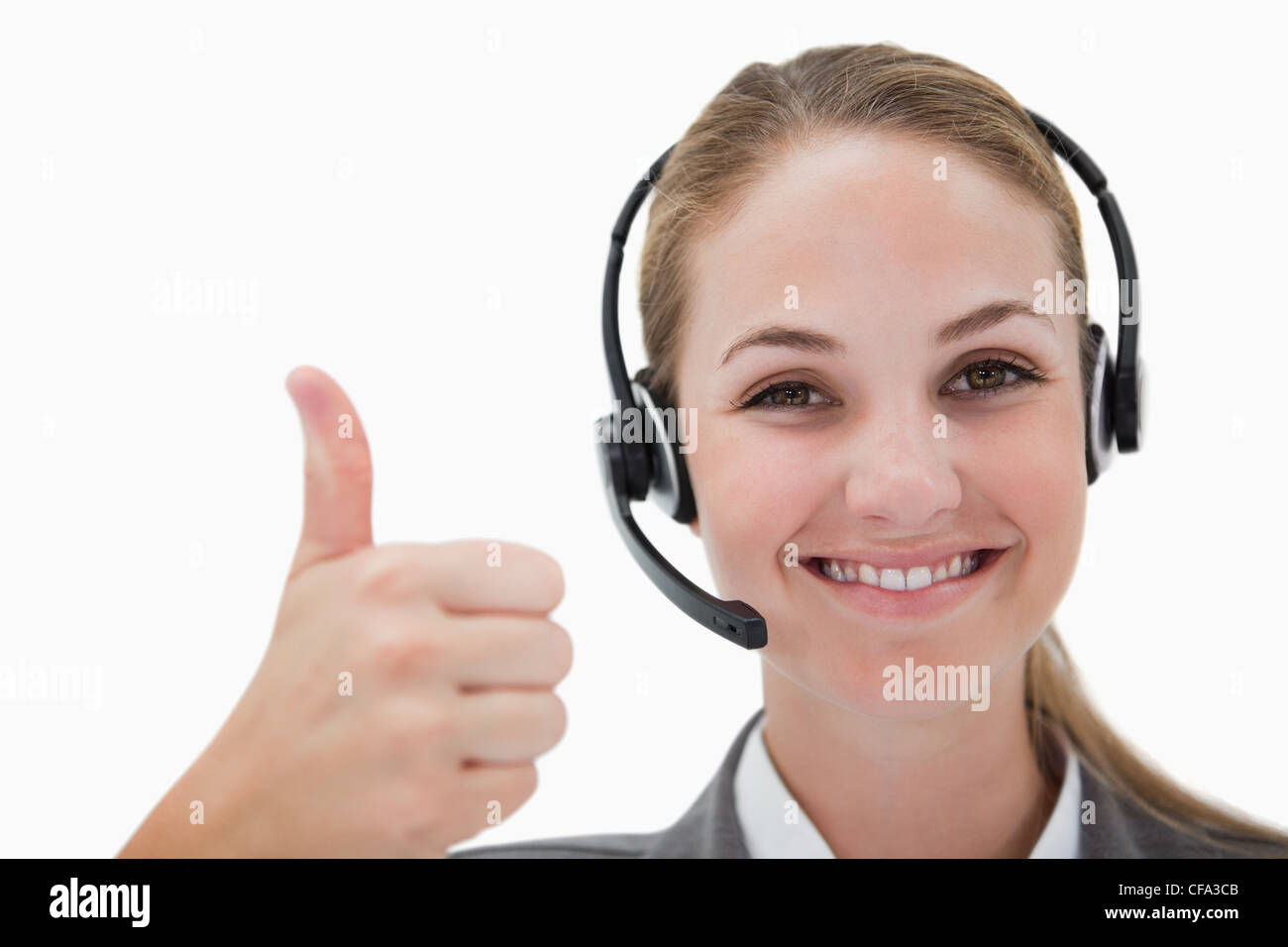 Smiling call centre agent giving thumb up Banque D'Images