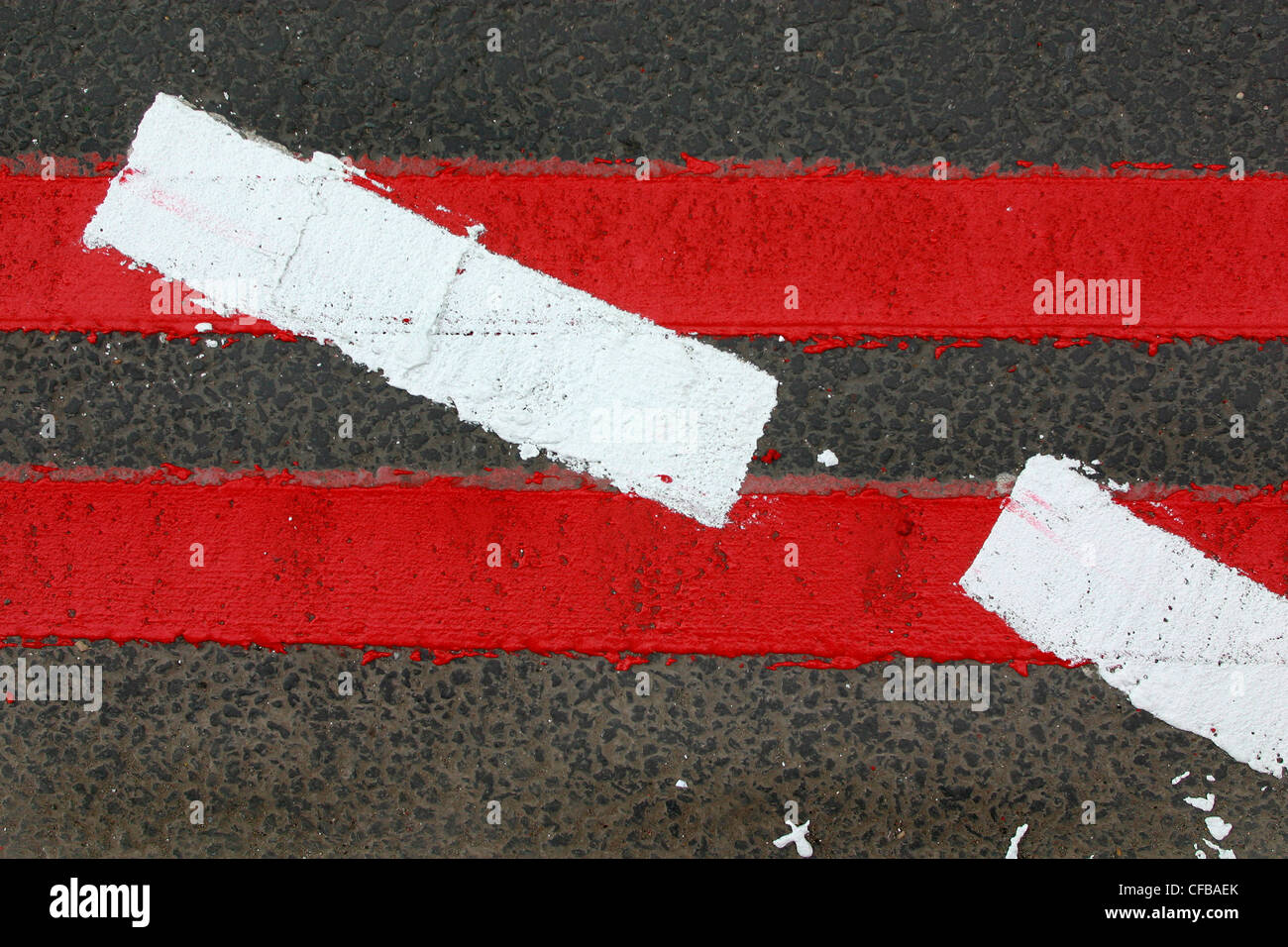 Le marquage routier nouvellement peintes sur les itinéraires rouge indiquant l'absence de stationnement ou attendent le long des routes désignées, Londres, Royaume-Uni. Banque D'Images