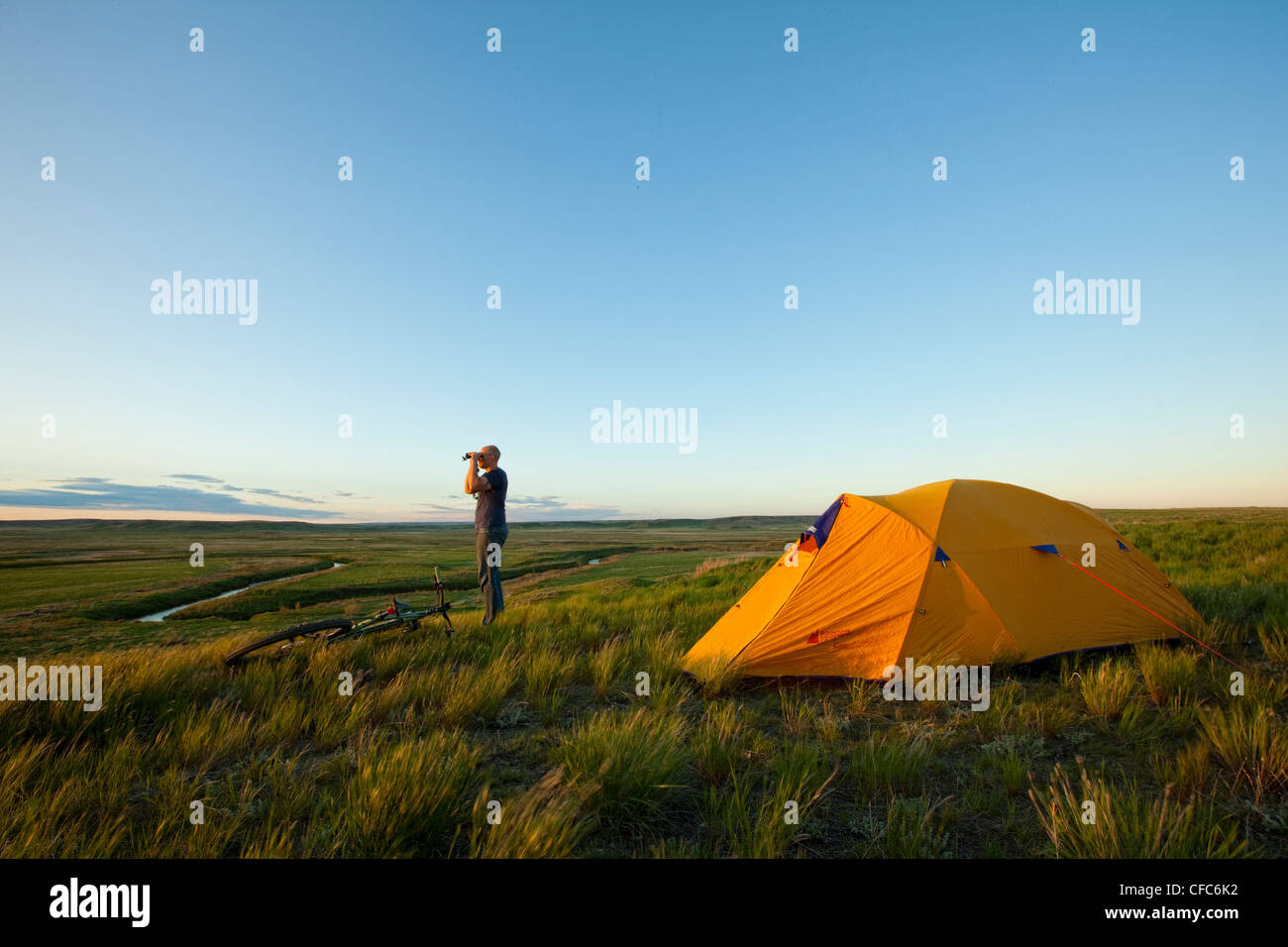 Personne regardant à travers des jumelles et camping dans le parc national des Prairies, en Saskatchewan. Banque D'Images