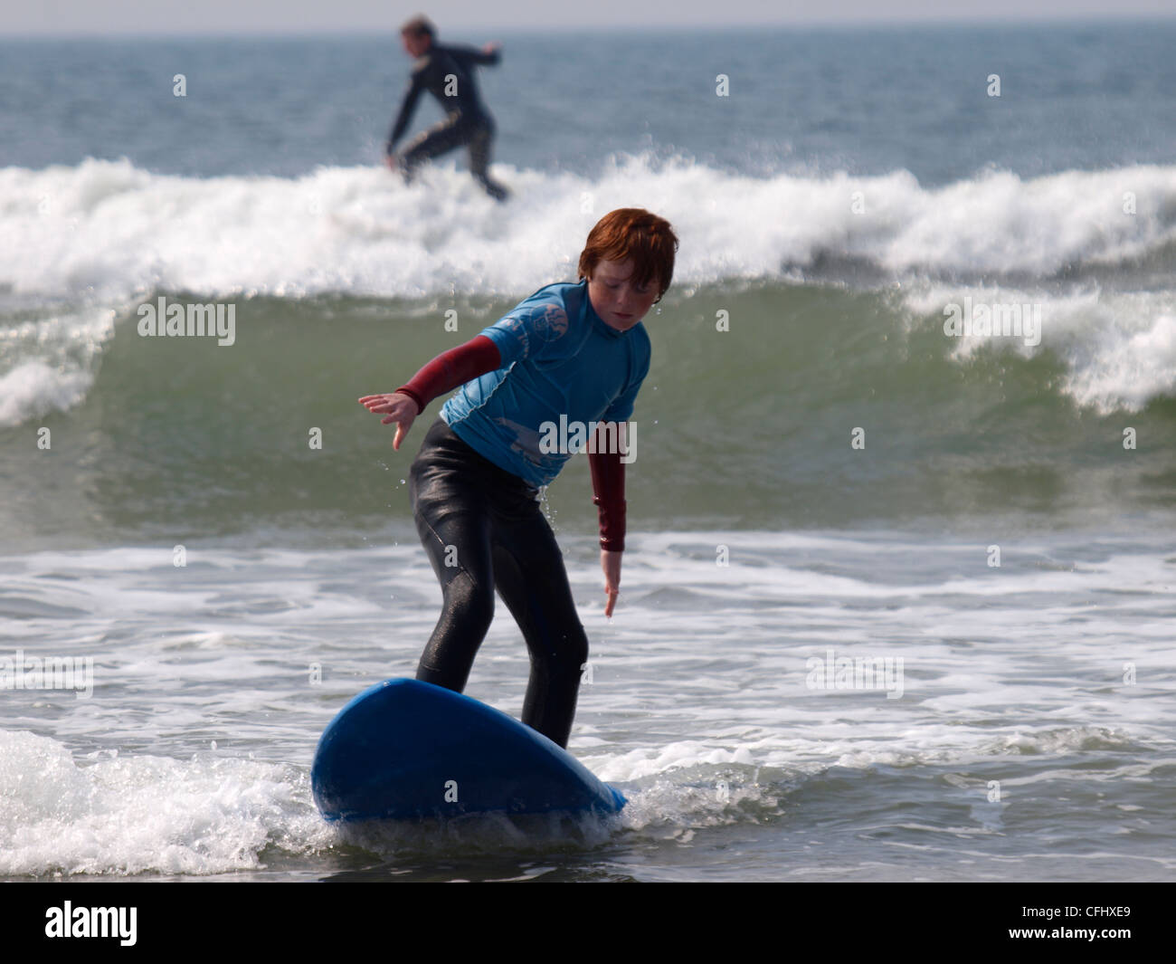 Jeune garçon apprendre à surfer, Bude, Cornwall, UK Banque D'Images