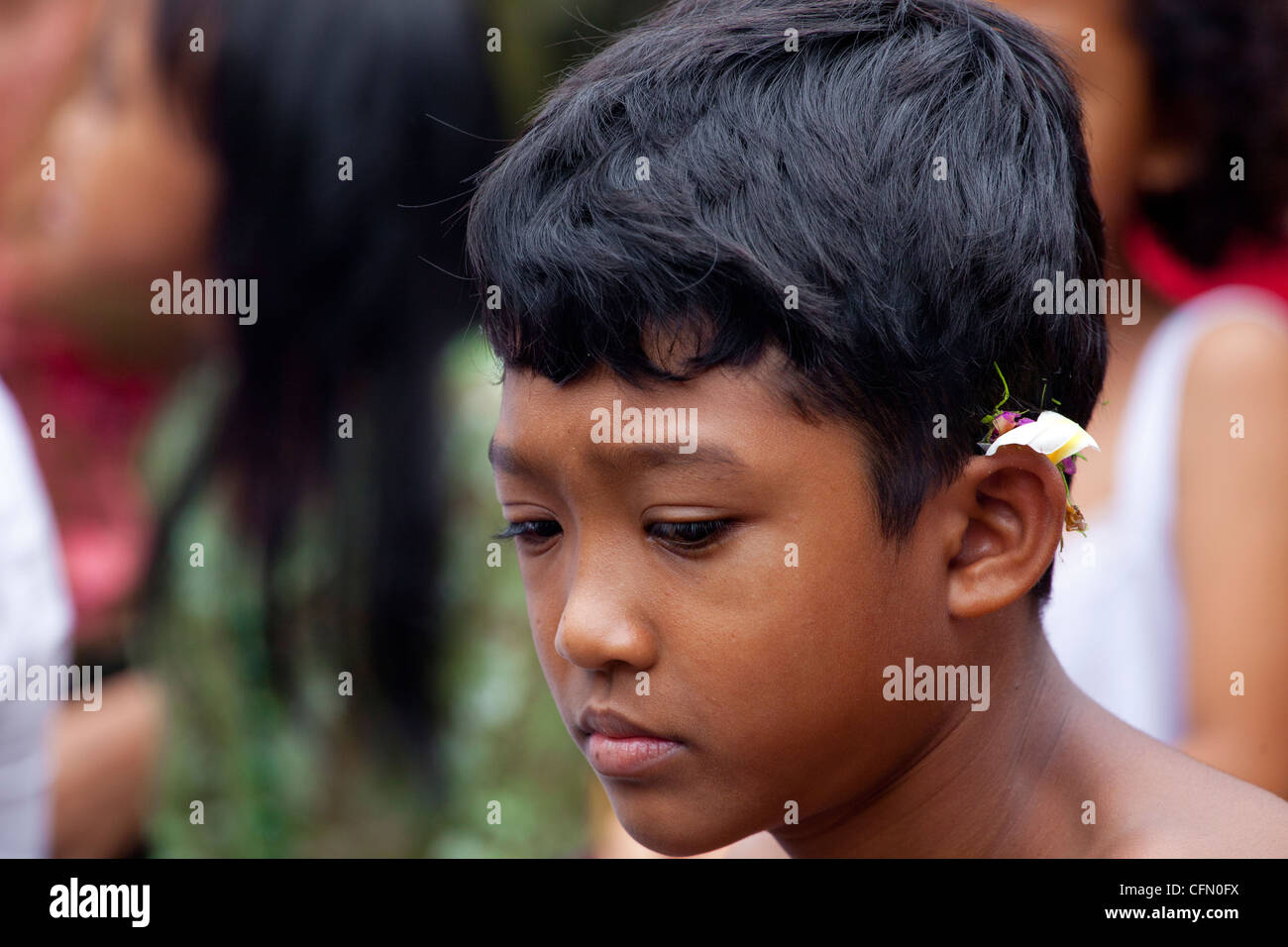 Garçon priant lors d'une cérémonie religieuse à Bali, Indonésie, du Pacifique Sud, en Asie du sud-est, en Asie. Banque D'Images