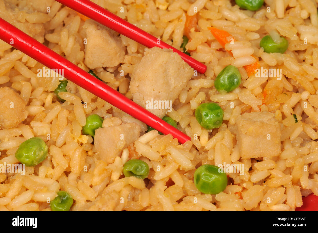 Macro Close-up de baguettes avec riz frit au poulet et légumes Banque D'Images