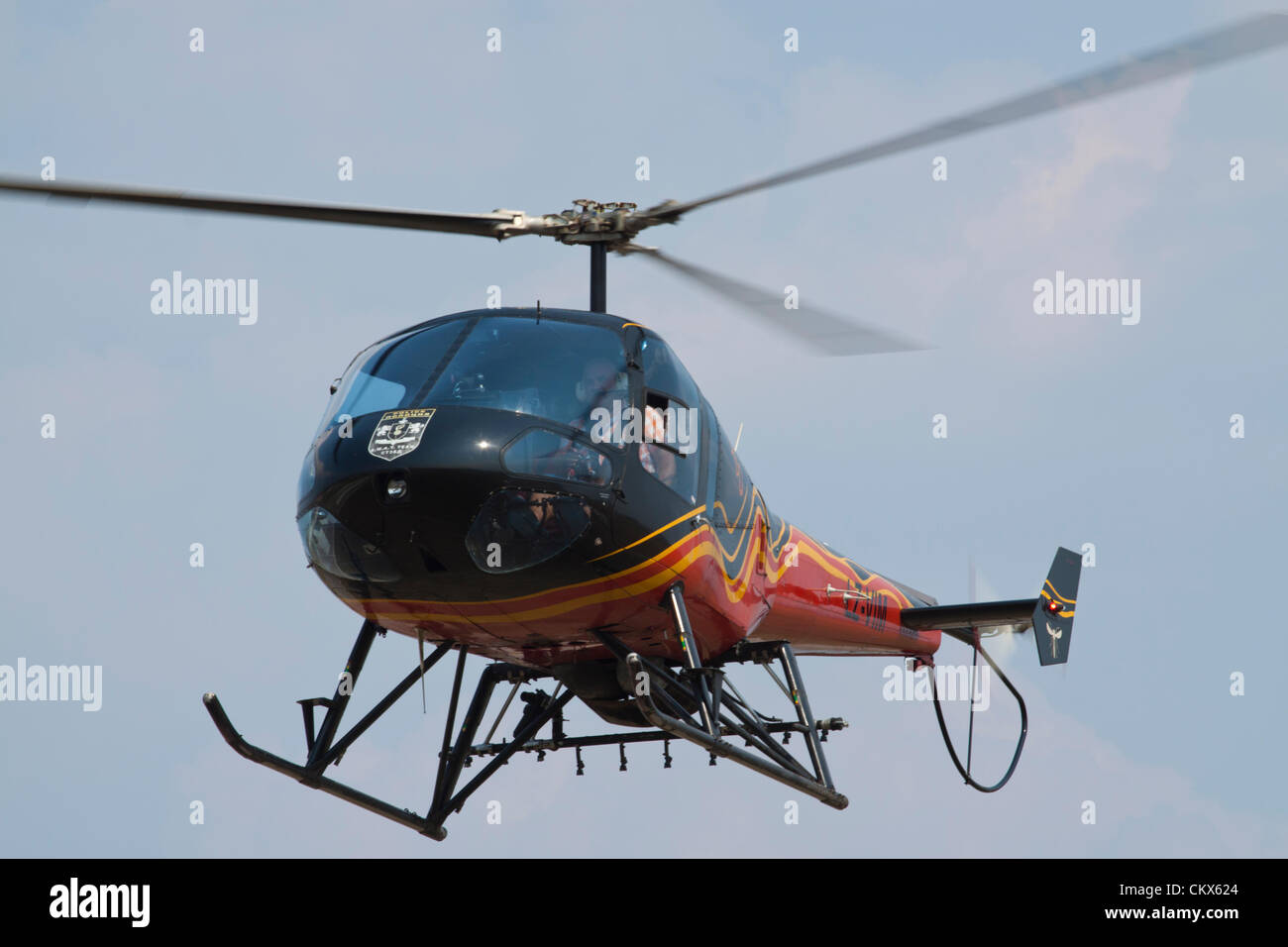 Lesnovo, Bulgarie, 24e Août 2012. Hélicoptère Enstrom 480 lumière planant au-dessus du champ de l'air. Cet avion est équipé comme une récolte duster (notez le rack des buses de pulvérisation sous le fuselage). Credit : Johann Brandstatter / Alamy Live News Banque D'Images