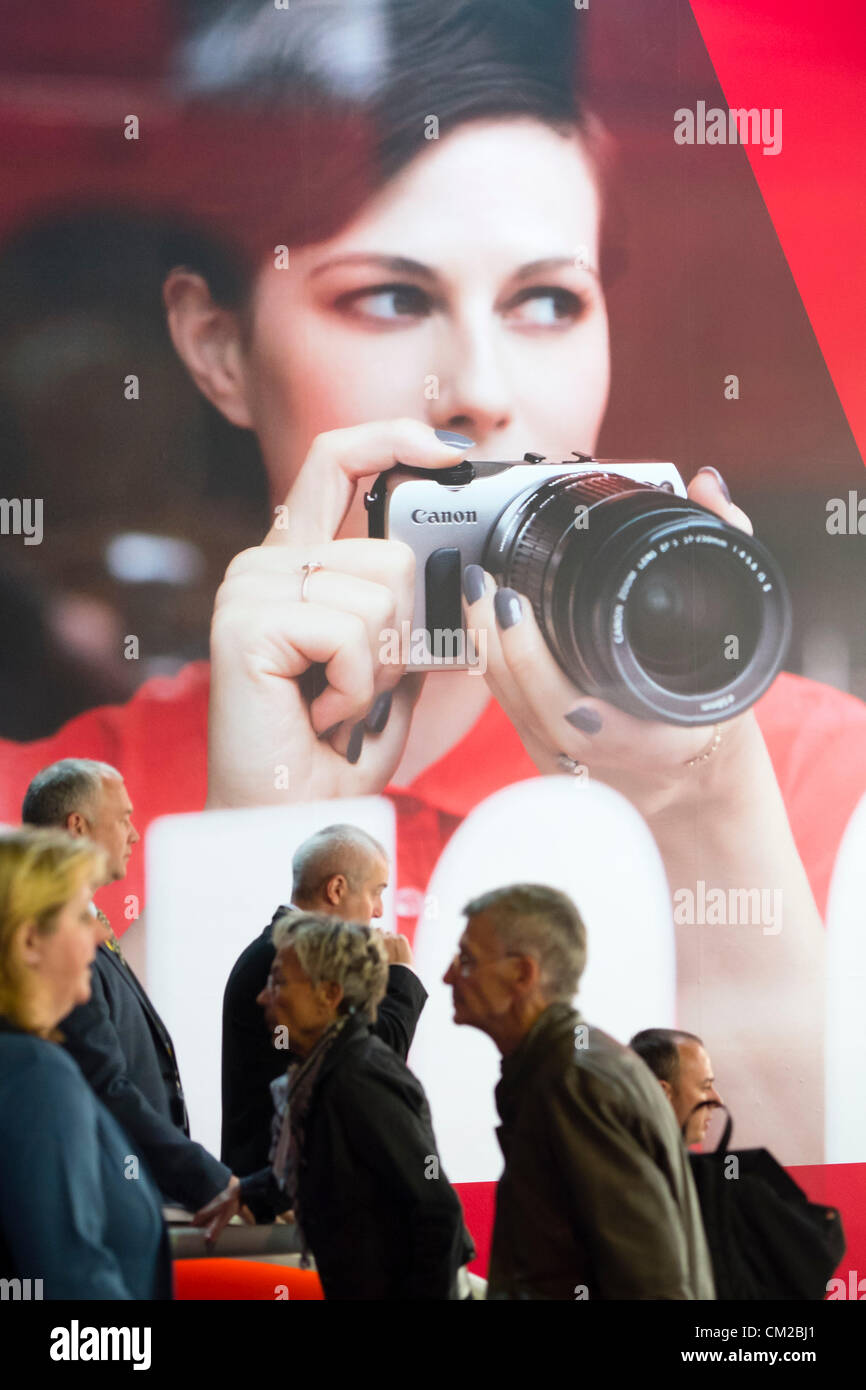 Les visiteurs passent devant la grande affiche publicité appareil photo Canon sur deuxième journée bi-annuelle de la photographie et imagerie Photokina salon de Cologne en Allemagne ; le mercredi 19 septembre 2012. Banque D'Images