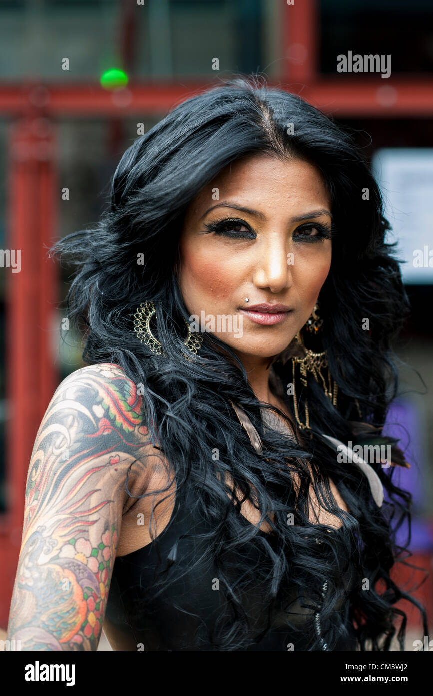 28 septembre 2012, Londres, Royaume-Uni. La 8ème Convention de Tatouage de Londres commence aujourd'hui au quai du tabac dans l'East End de Londres. Tattoo tatoueurs et fans du monde entier affluent vers le lieu. Lepa, un modèle de l'Agence de modèle d'Arts foncé pose pour la caméra en montrant son bras tatoué et à l'épaule. Banque D'Images