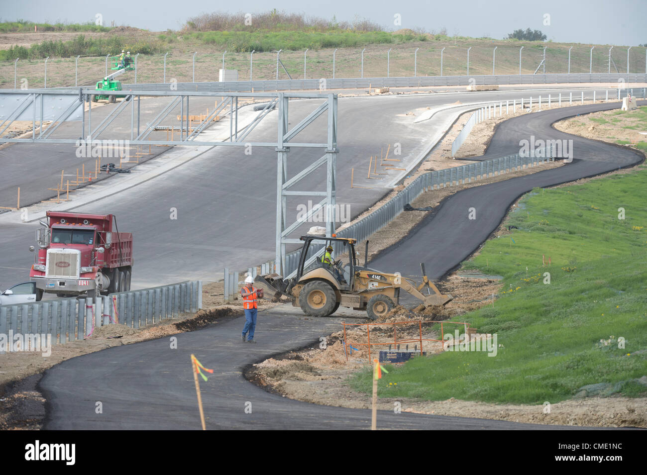 Trois mois avant une course de Formule Un à la mi-novembre, les entrepreneurs travaillent autour de l'horloge pour fermer le circuit des Amériques racetrack dans le centre du Texas Austin à l'extérieur. Les 3,4 km de voie dispose d'une forte pente, à son tour, l'un suivi d'un virage à gauche sévère après les 113 pieds de hauteur. Banque D'Images