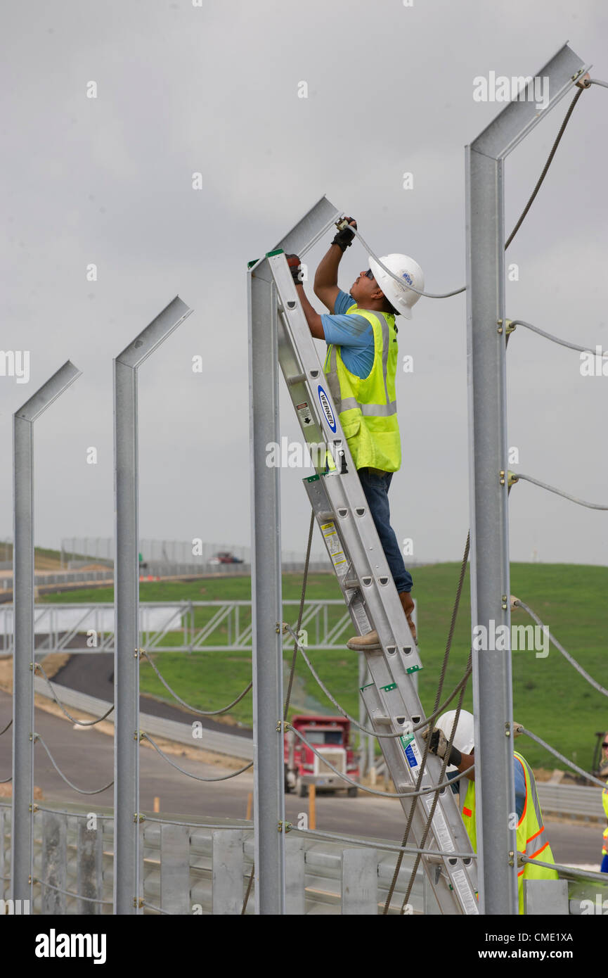 Trois mois avant une course de Formule Un à la mi-novembre, les entrepreneurs travaillent autour de l'horloge pour fermer le circuit des Amériques racetrack dans le centre du Texas Austin à l'extérieur. Les 3,4 km de voie dispose d'une forte pente, à son tour, l'un suivi d'un virage à gauche sévère après les 113 pieds de hauteur. Banque D'Images