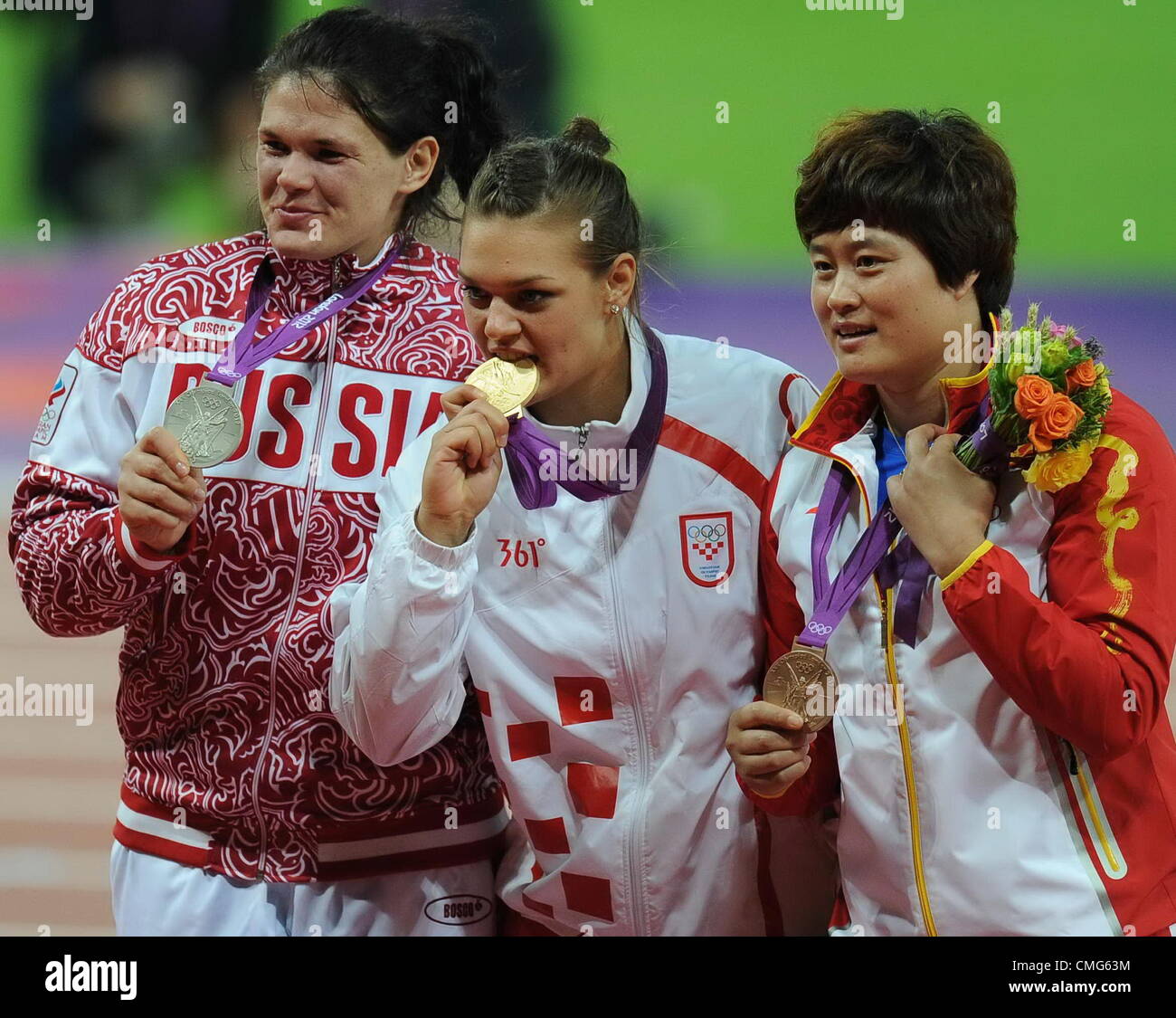 05.08.2012. Londres, Angleterre. Londres, Angleterre ; Li Yanfeng médaillé de bronze de la Chine , l'or olympique Sandra Perkovic de Croatie et d'argent olympique Darya Pishchalnikova de Russie posent sur le podium lors de la cérémonie de remise des médailles pour les lancer au Jour 9d les Jeux Olympiques de 2012 à Londres au Stade Olympique. Banque D'Images