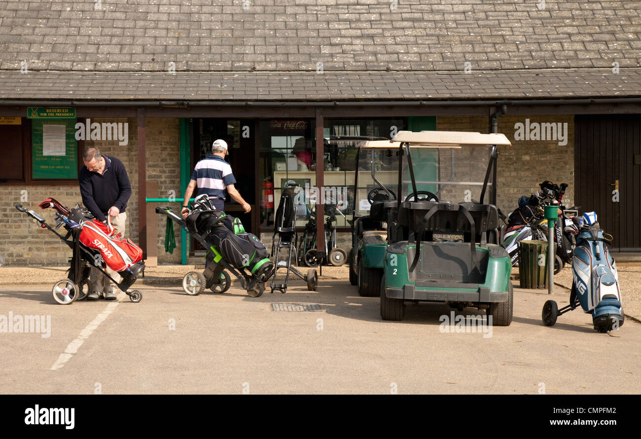 Les golfeurs de la préparation de leurs chariots à l'extérieur de la boutique de golf, club de golf de Newmarket, Suffolk, UK Banque D'Images