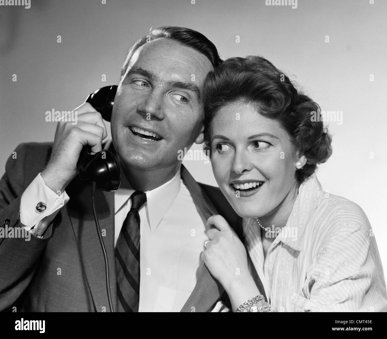 Années 1950 Années 1960 MAN TALKING ON TELEPHONE WOMAN LEANING DANS D'ÉCOUTER PISCINE Banque D'Images