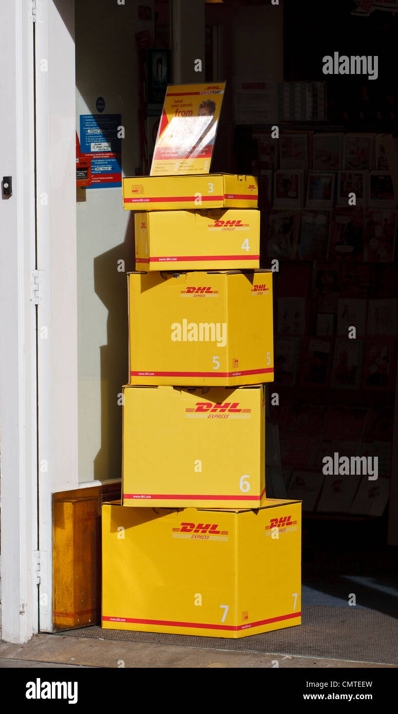 Pile de boîtes de DHL dans l'arrêt shop doorway Banque D'Images