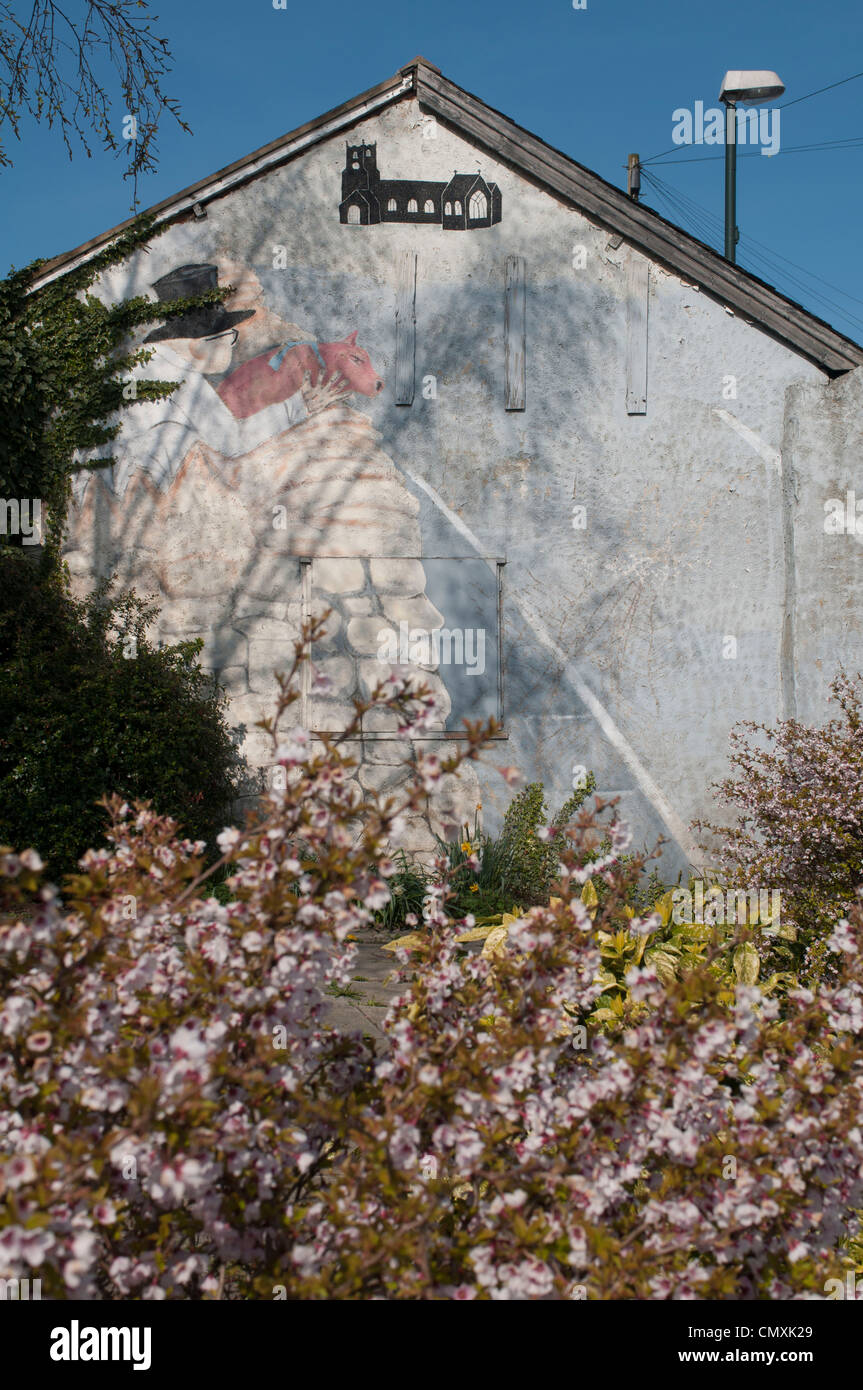 L'homme avec le cochon sur le mur, Kippax (M. Kershaw) Banque D'Images