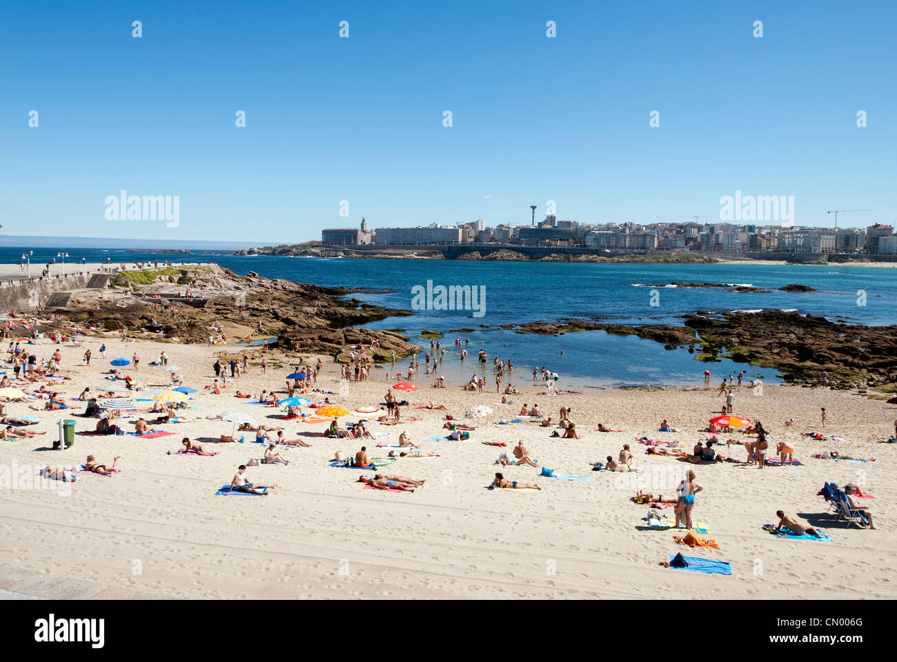 Les gens se baigner de soleil à la plage de la plage de Riazor - Corogne, Galice - Espagne Banque D'Images