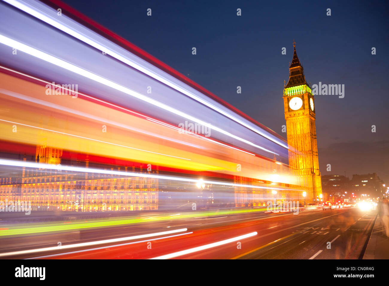 Big Ben Clock Tower Chambres du Parlement de nuit avec lumières floues de passer en premier plan bus red London London England UK Banque D'Images