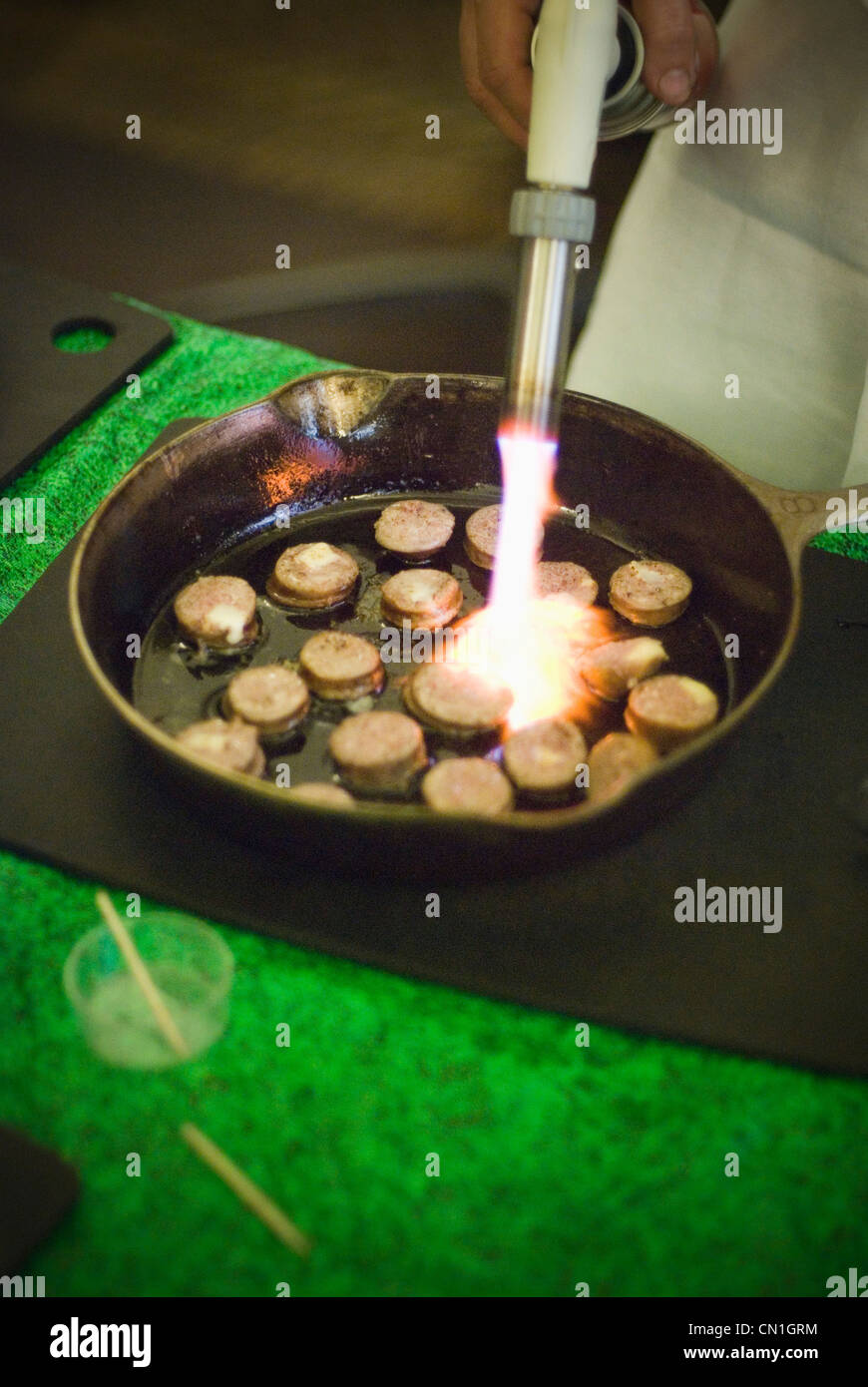 La cuisson de la saucisse dans une casserole avec un chalumeau Banque D'Images