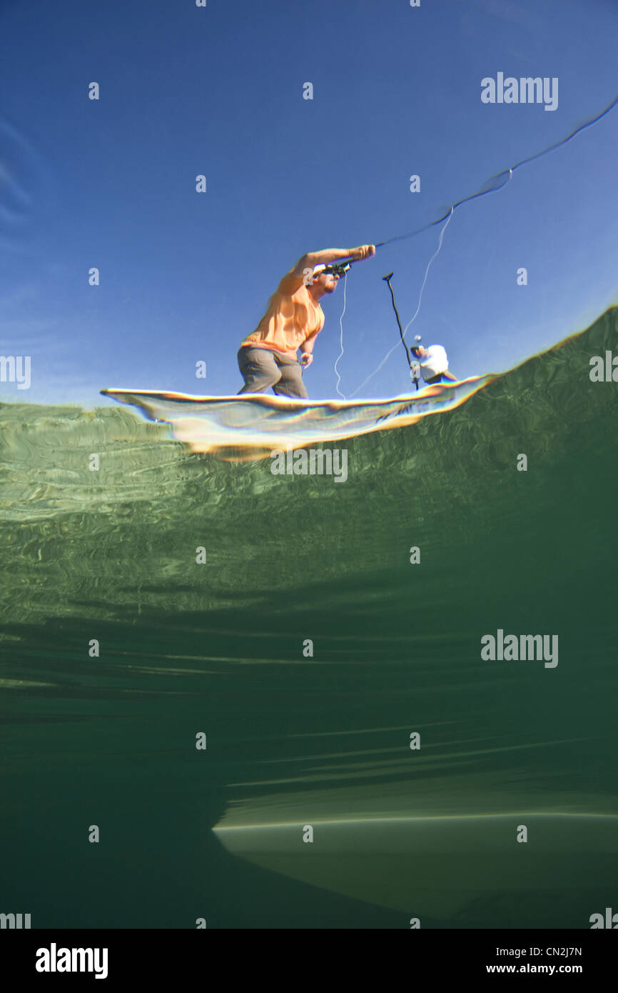 Plus de et sous-Vue de deux hommes La pêche de mouche en bateau près de Shipwreck, Florida Keys, USA Banque D'Images