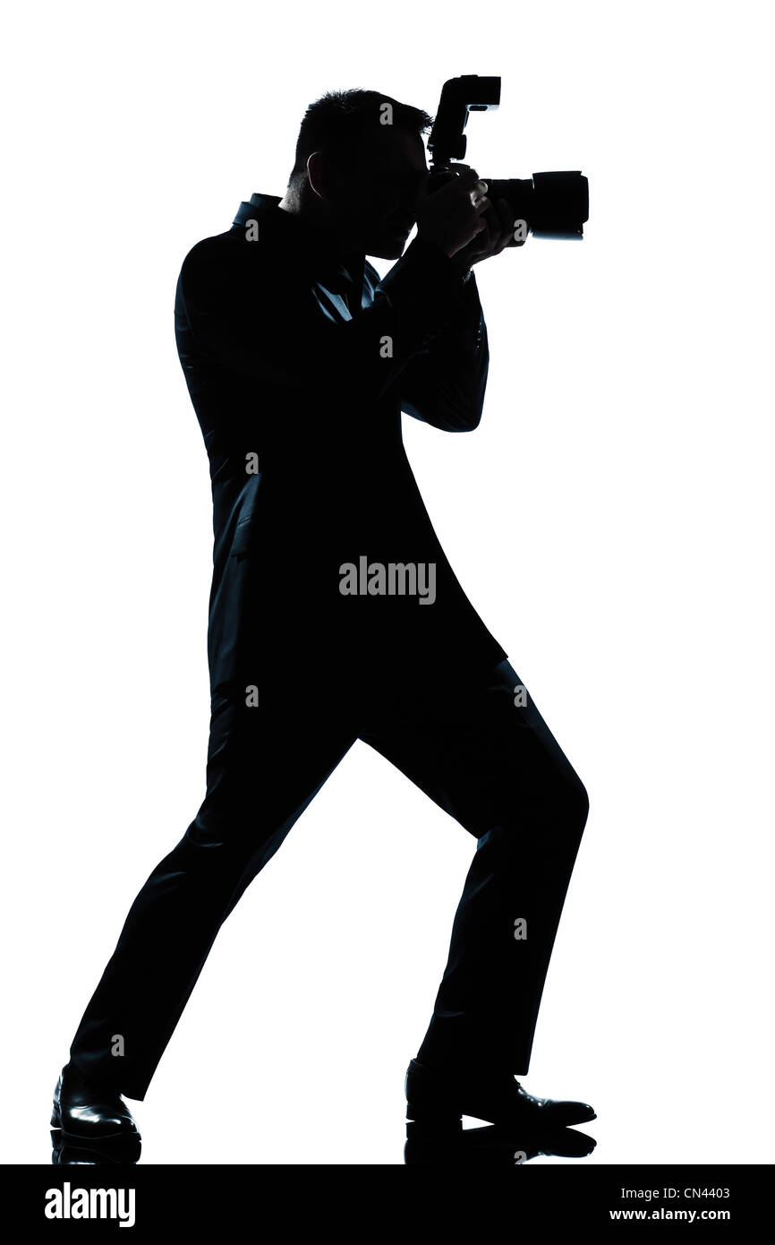 Un homme de race blanche silhouette en pleine longueur photographe studio isolé sur fond blanc Banque D'Images