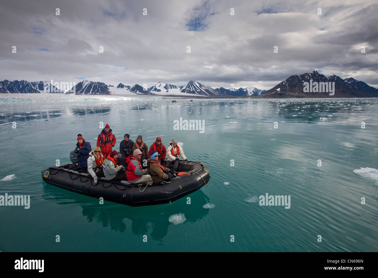 La Norvège, Svalbard, Spitzberg, touristes motoring en zodiac près de Lilliehøøk Glacier dans Krossfjorden sur matin d'été Banque D'Images