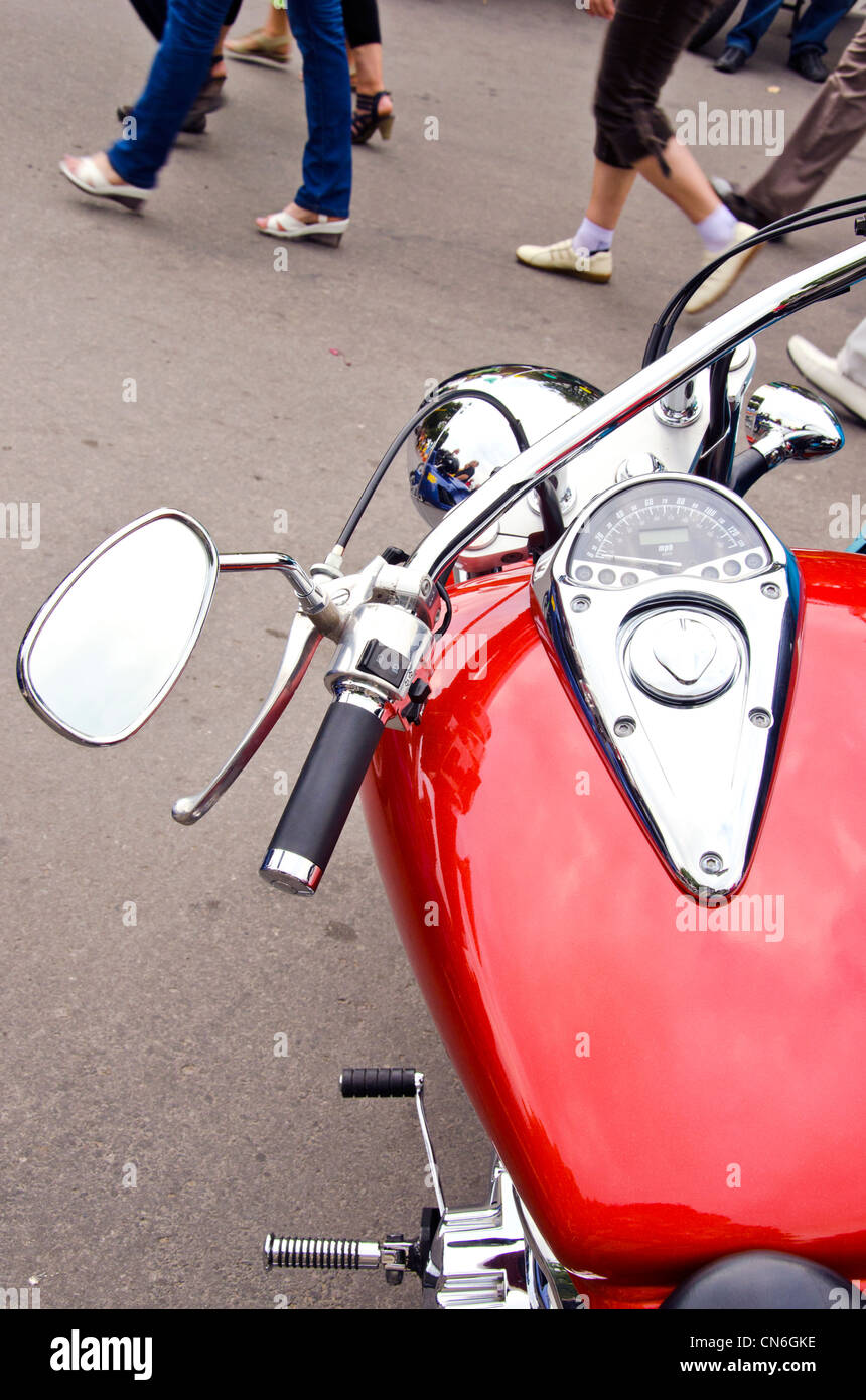 Compteur moto brillant bûcheron rouge roue réservoir de carburant. Les gens rue de marche pied. Banque D'Images