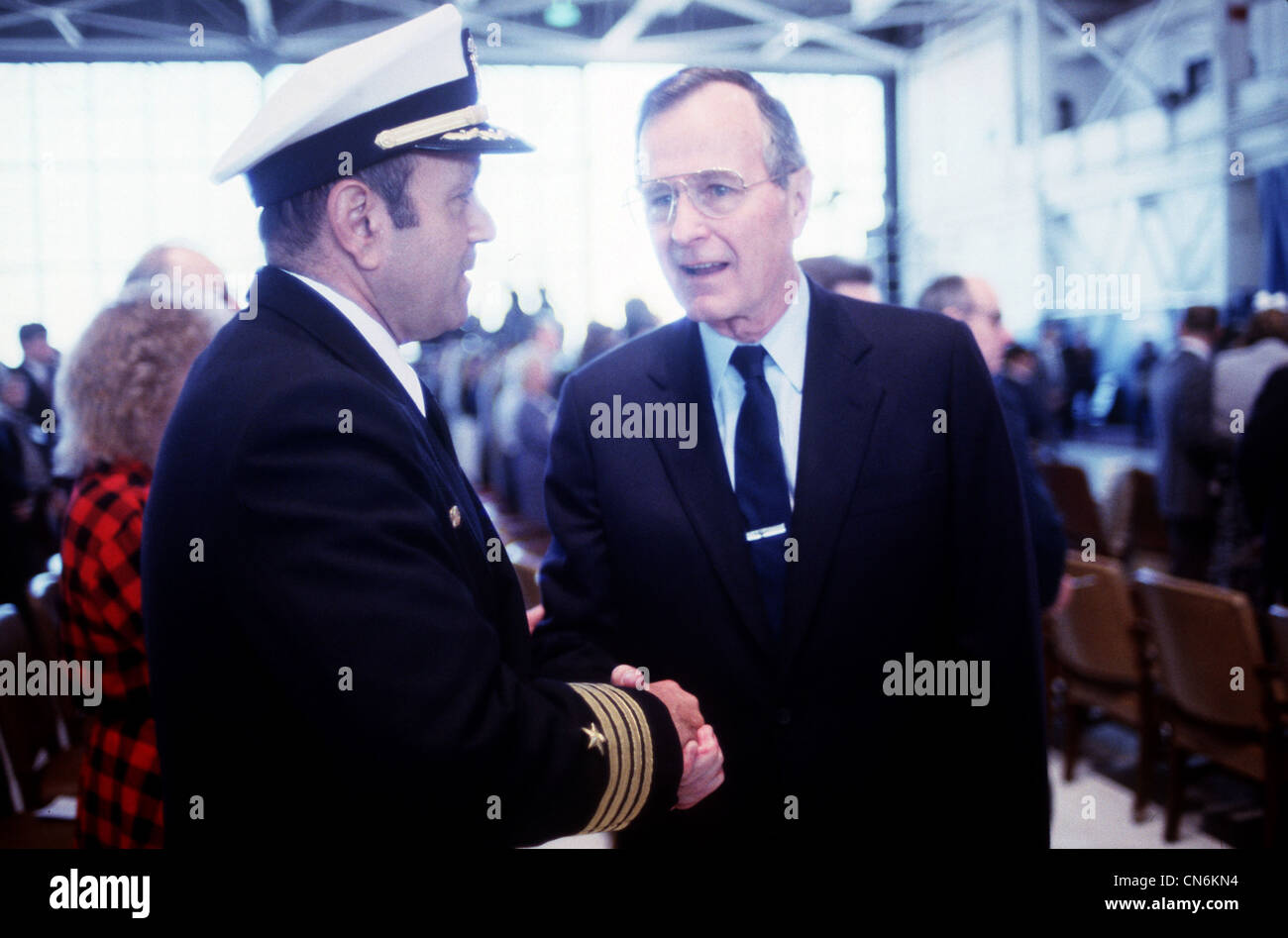 Président George H.W. Bush parle avec le capitaine Fred P. Moosally, commandant du cuirassé USS Iowa (BB-61), lors d'un service commémoratif pour les 47 membres d'équipage tués lors d'une explosion à bord du navire. L'explosion s'est produite dans la tourelle de canon no 2 de 16 pouces alors que l'Iowa effectuait des exercices de fusillade de routine à environ 300 milles au nord-est de Porto Rico le 19 avril. Banque D'Images