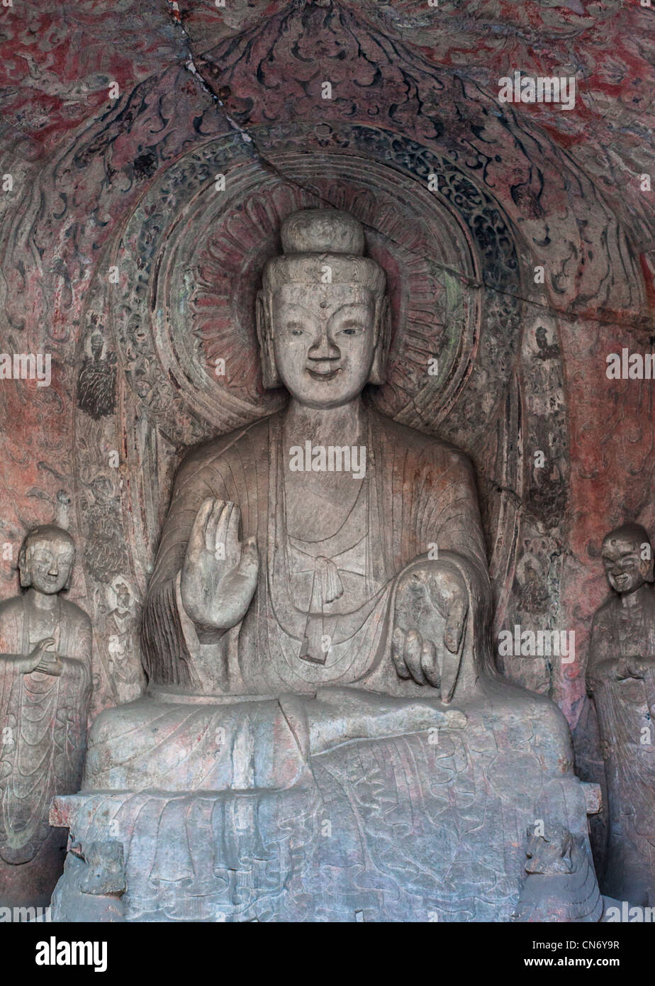 Sculptures en pierre de Bouddha et ses disciples au milieu grotte Binyang dans les grottes de Longmen site en Chine Banque D'Images
