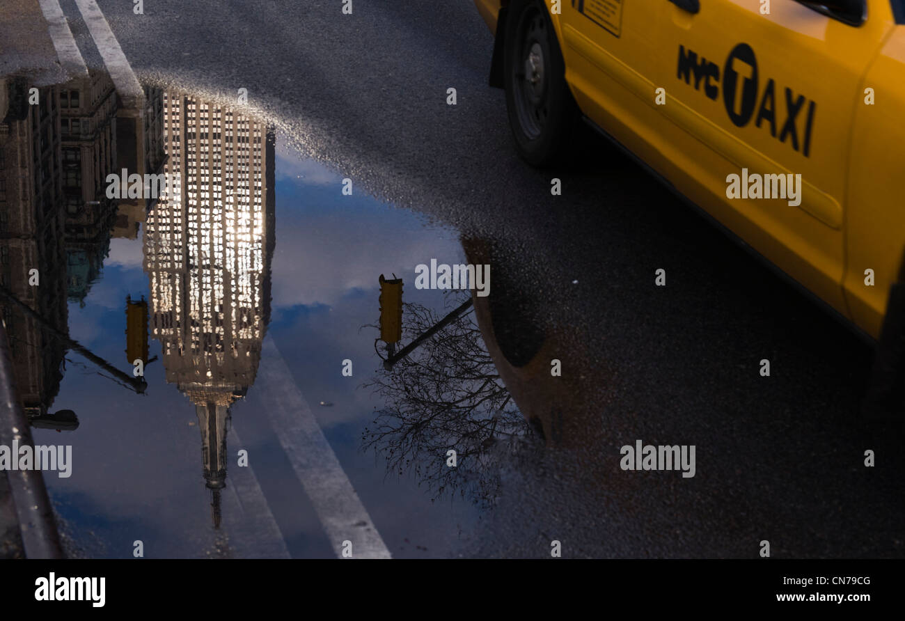 Taxi jaune conduit par une réflexion de l'Empire State Building 5e Avenue à New York, NY, États-Unis, Janvier 1, 2010. (Adrien Veczan) Banque D'Images