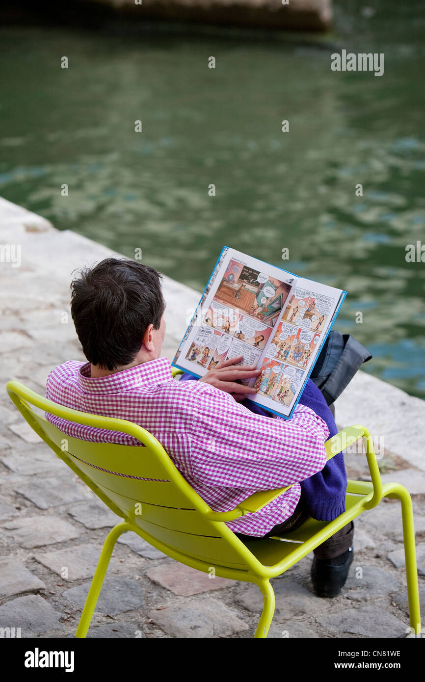 France, Paris, des berges de la Seine, classées au Patrimoine Mondial par l'UNESCO, Paris Plage, l'homme de la lecture d'un comics Banque D'Images