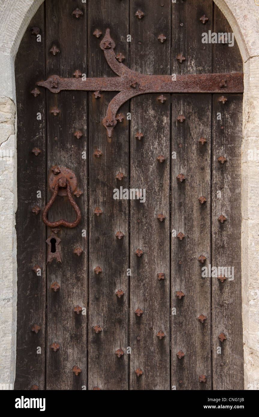 L'ancien-météorologiques battus porte latérale de l'église de St Michel et tous les Anges, dans le village d'Littlebredy, dans le Dorset, Angleterre, Royaume-Uni. Banque D'Images