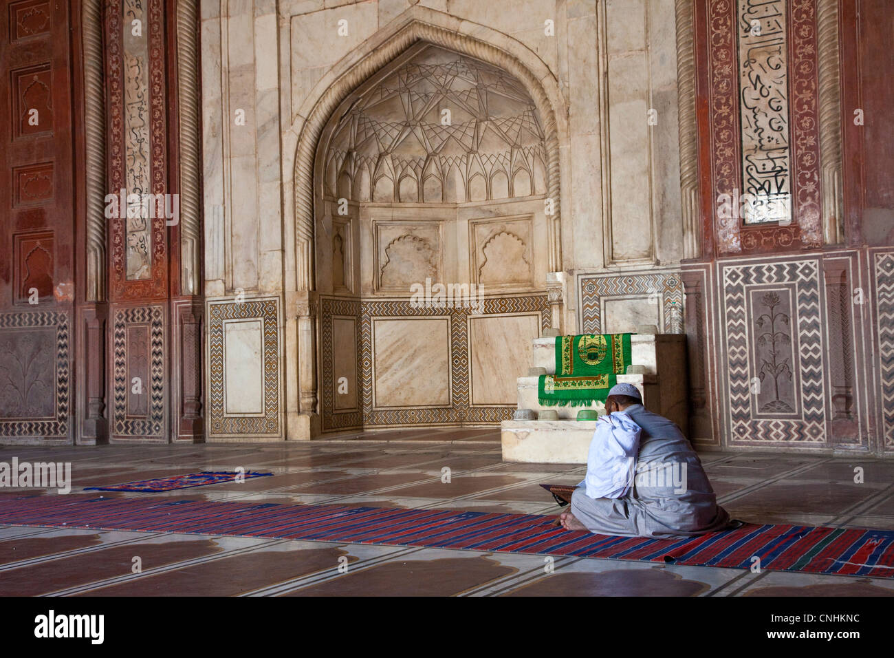 Agra, Inde. L'intérieur de la mosquée du Taj Mahal. La lecture de l'Imam du Coran en attendant l'heure de la prière. Banque D'Images