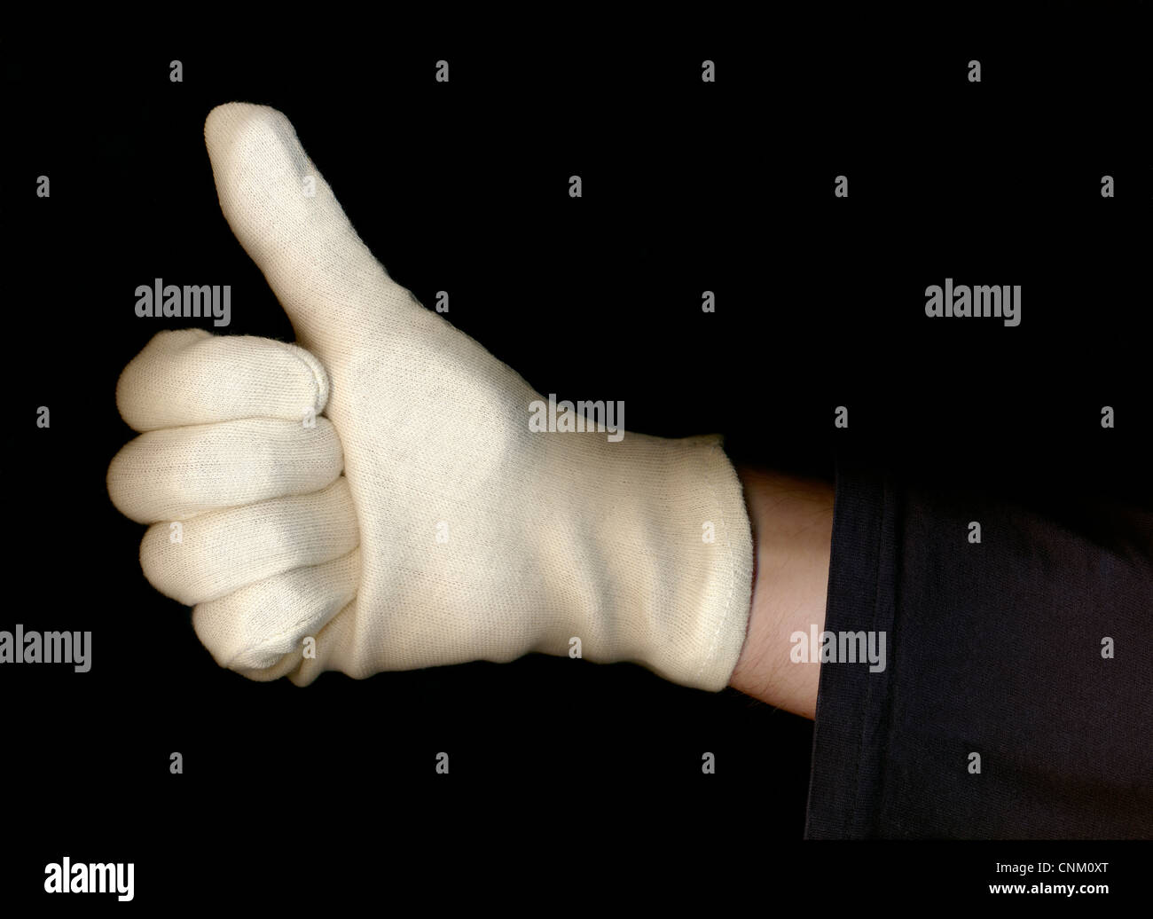 La main avec un gant blanc faire thumbs-up connexion symbolique pour 'okay' Banque D'Images
