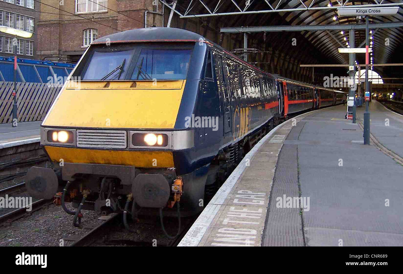 Class 91 n° 91132 à la tête d'un râteau rénové de Mark IV Transport, tous en uniforme, livrée gner à London Kings Cross Banque D'Images