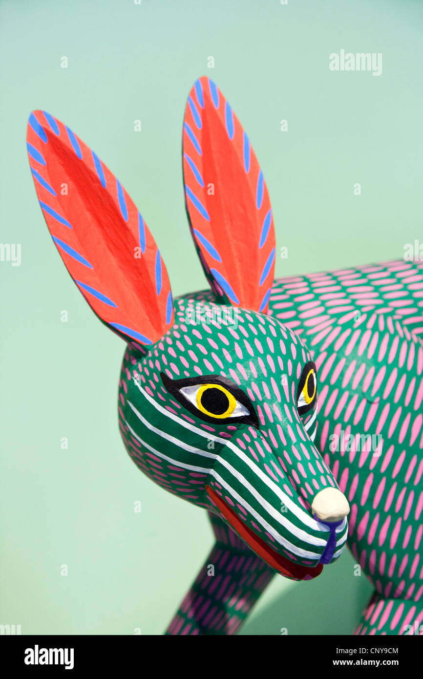 Afficher bois polychrome sculpture d'art populaire avec des yeux féroces coyote orbes jaunes, élèves noirs & long épis rouge alerte Museo de Arte Popular Mexico City Banque D'Images