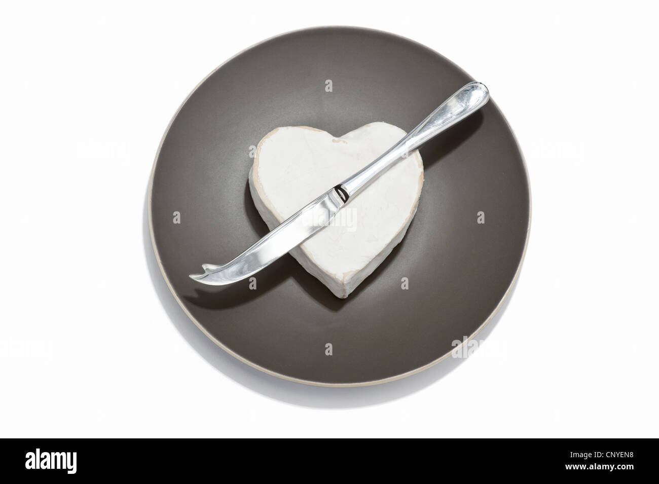 Un fromage en forme de coeur et de fromage sur une assiette couteau Banque D'Images