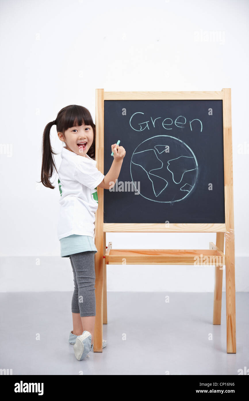 Une fille sur green globe peinture tableau noir Banque D'Images