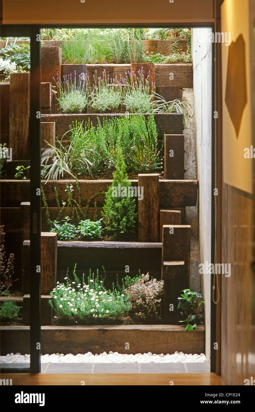 Voir par porte coulissante donnant sur terrasse avec jardin au-delà Banque D'Images