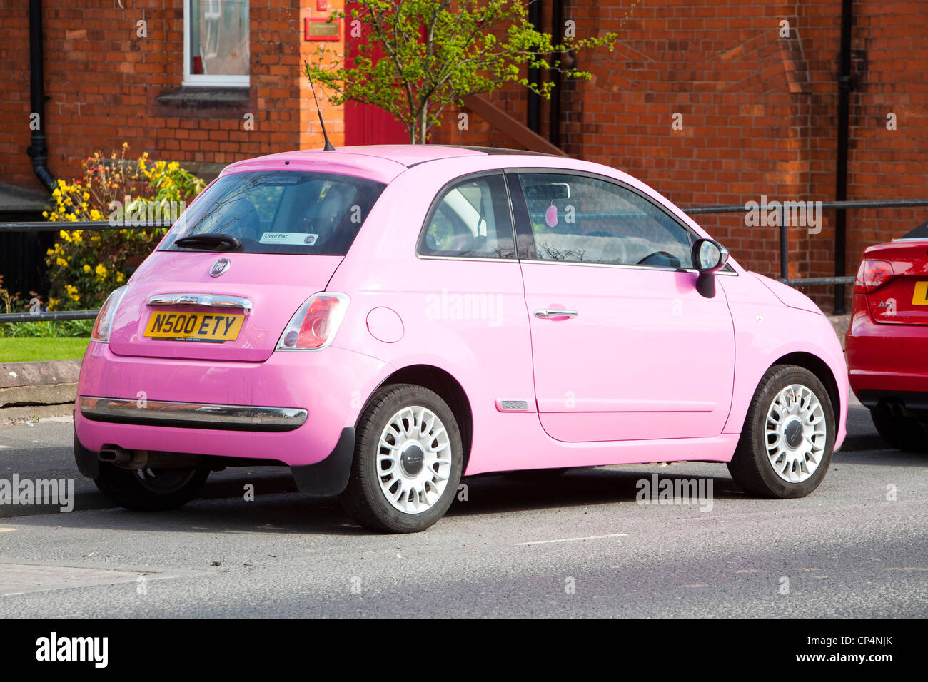 Une Fiat 500 rose voiture qui n'a jusqu'à 70 au gallon stationné à Carlisle, Cumbria, Royaume-Uni. Banque D'Images