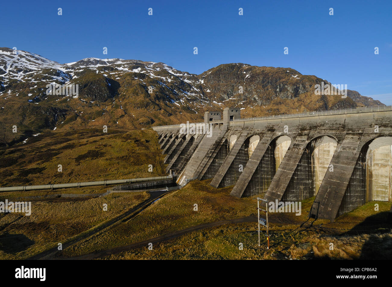 Ben Lawers barrage hydroélectrique près de Killin, Perthshire, Écosse, avec un fond de neige-striées hills. Banque D'Images