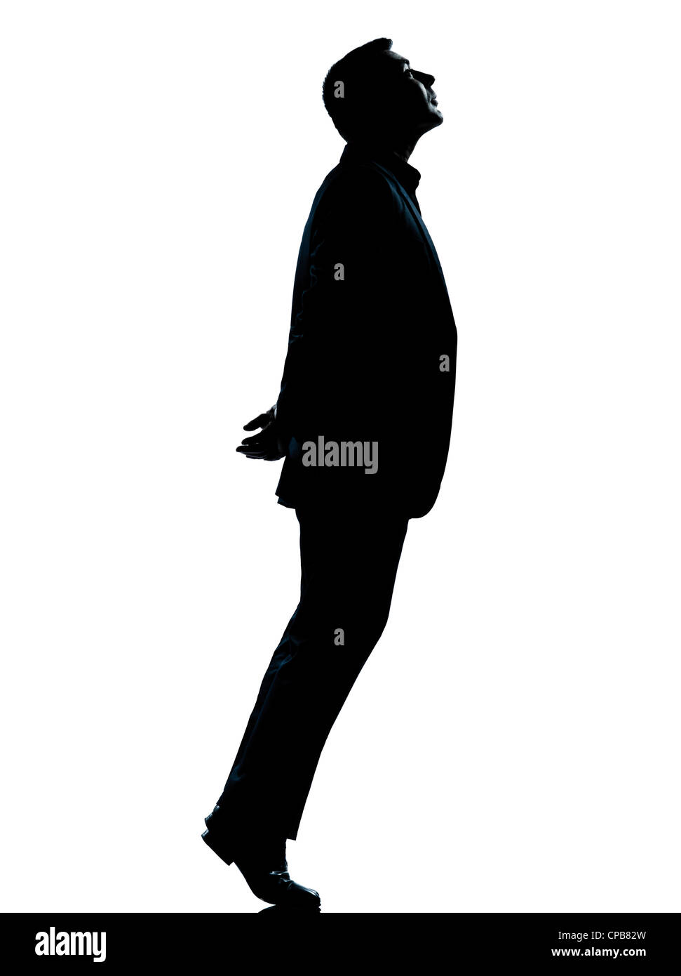 Un homme d'affaires de race blanche des pieds jusqu'à la silhouette debout en pleine longueur studio isolé sur fond blanc Banque D'Images