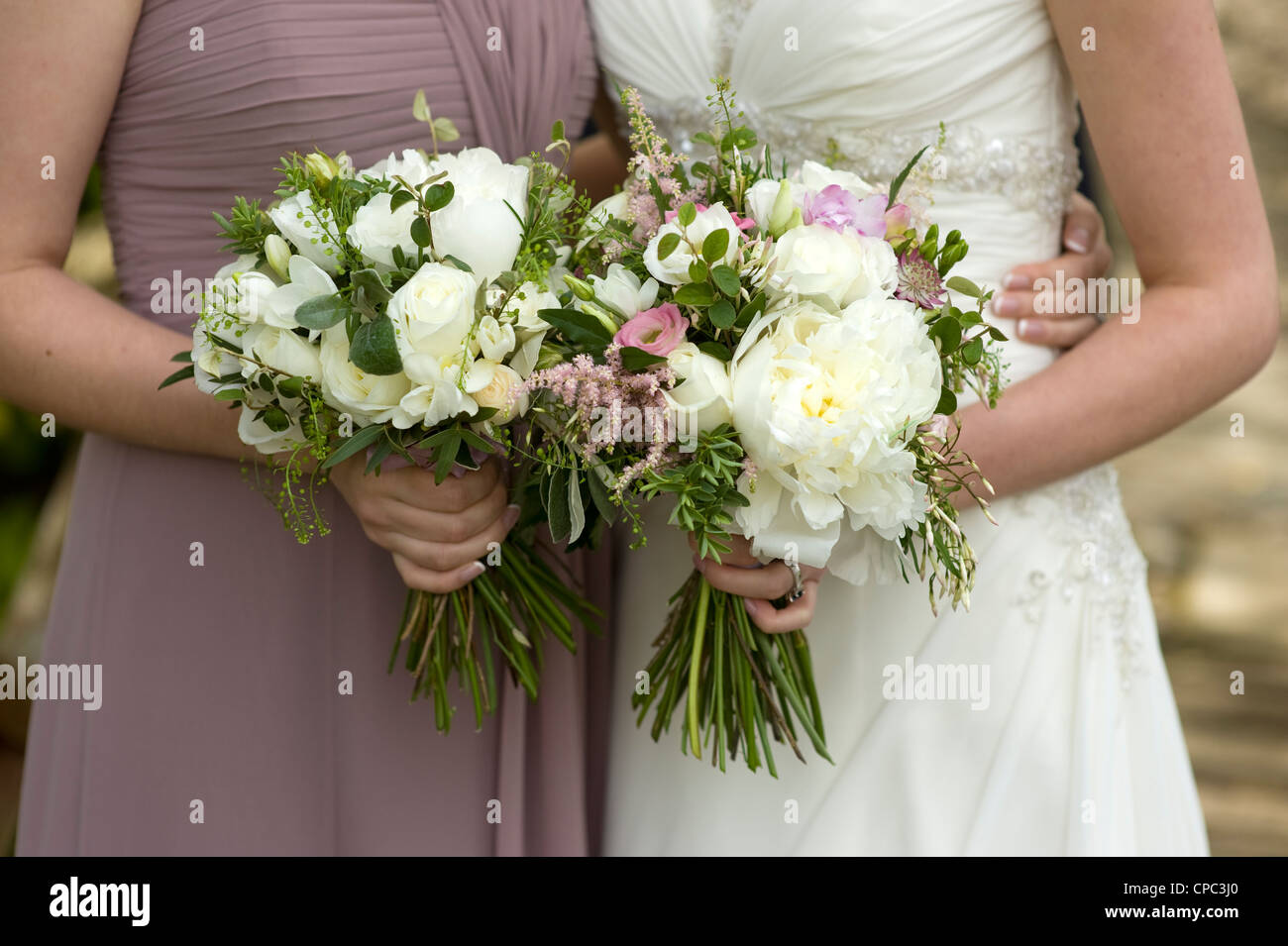 Mariée de demoiselle d'honneur et la tenue de mariage floral bouquets Banque D'Images