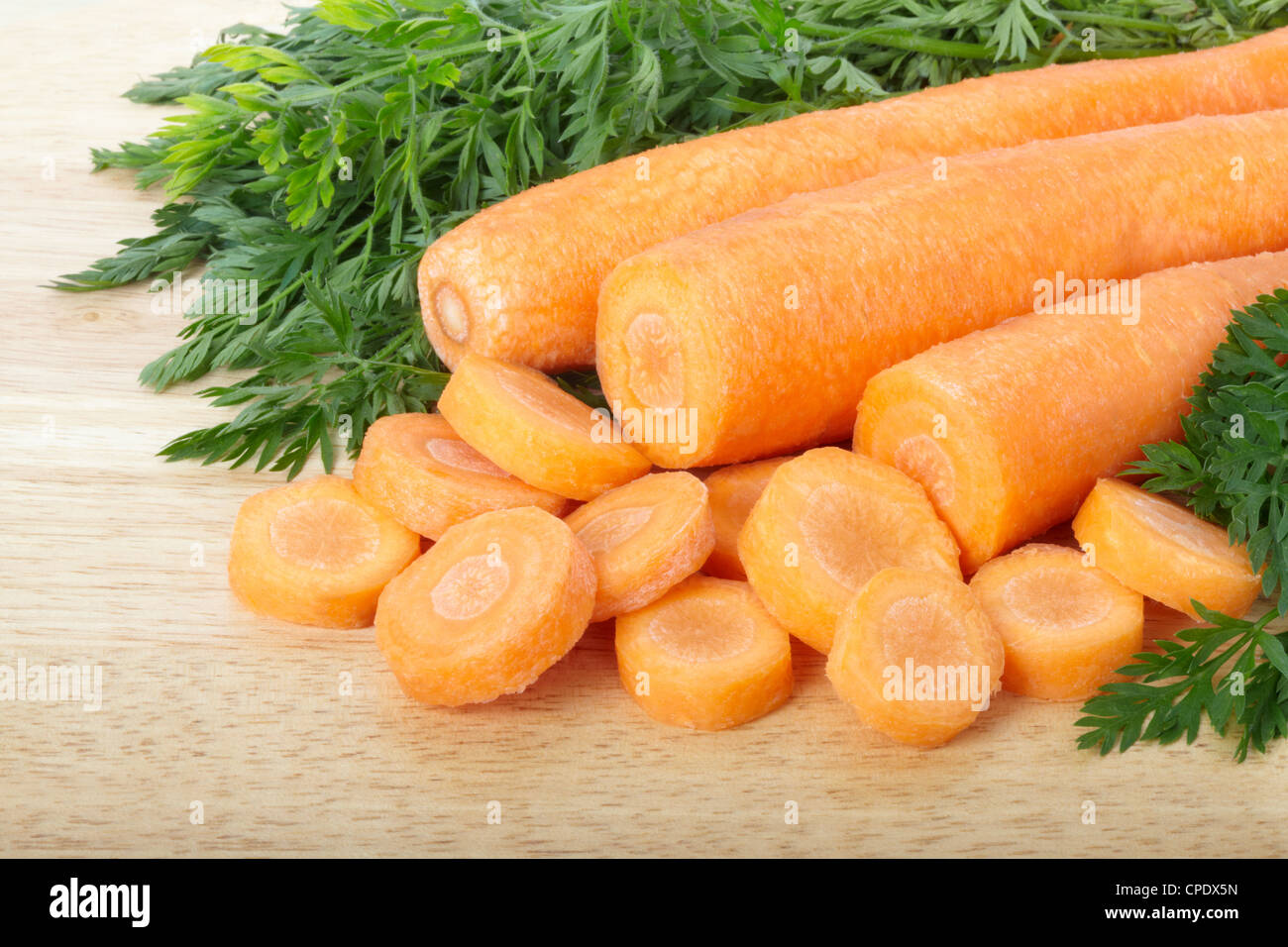 Les carottes en tranches sur une planche à découper Banque D'Images