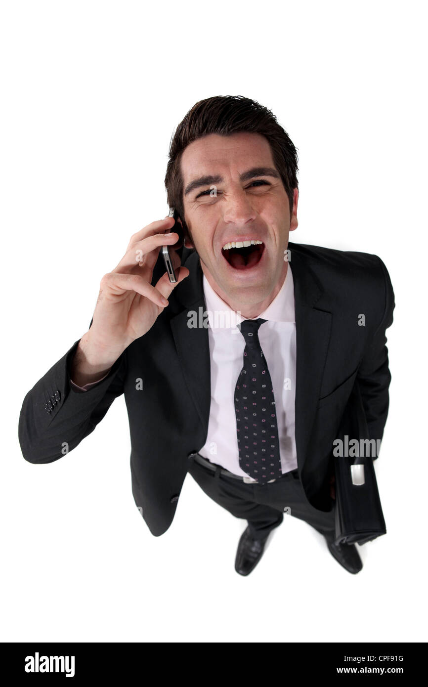 Businessman Laughing Out Loud pendant l'appel Banque D'Images