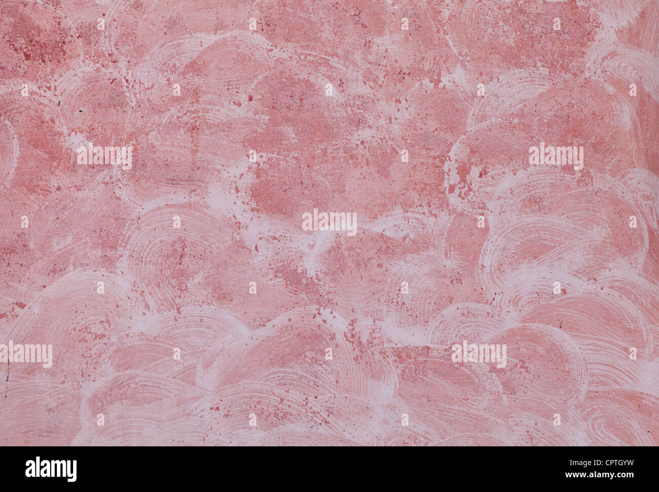 Mur de pierre peint rouge gros plan avec du plâtre texture Banque D'Images