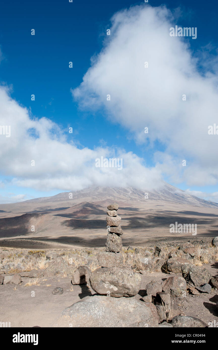 Cairn, vue de l'Est de l'autre côté de la colline de lave Kibo selle pour le sommet du Kilimandjaro couvert de nuages, Marangu Route Banque D'Images