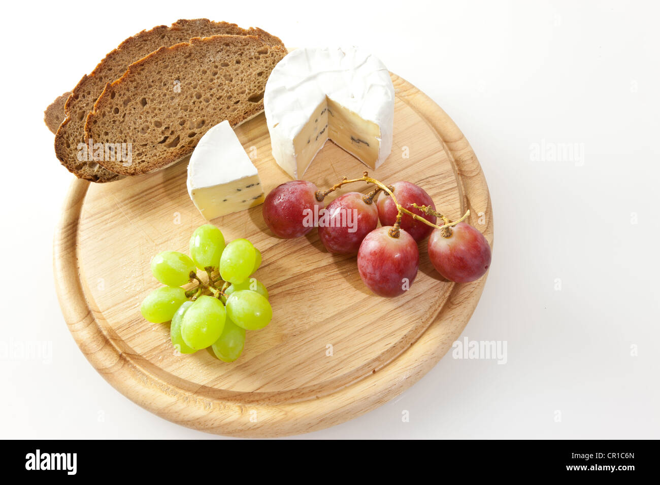 Le fromage bleu sur une planche avec du pain et des raisins Banque D'Images