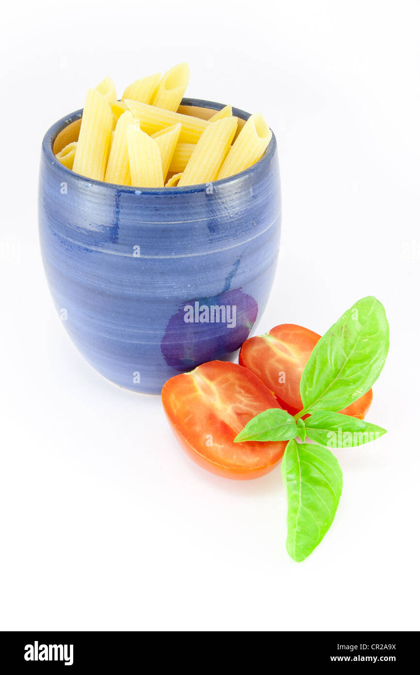 Pens pâtes dans un pot bleu avec tomates et basilic Banque D'Images