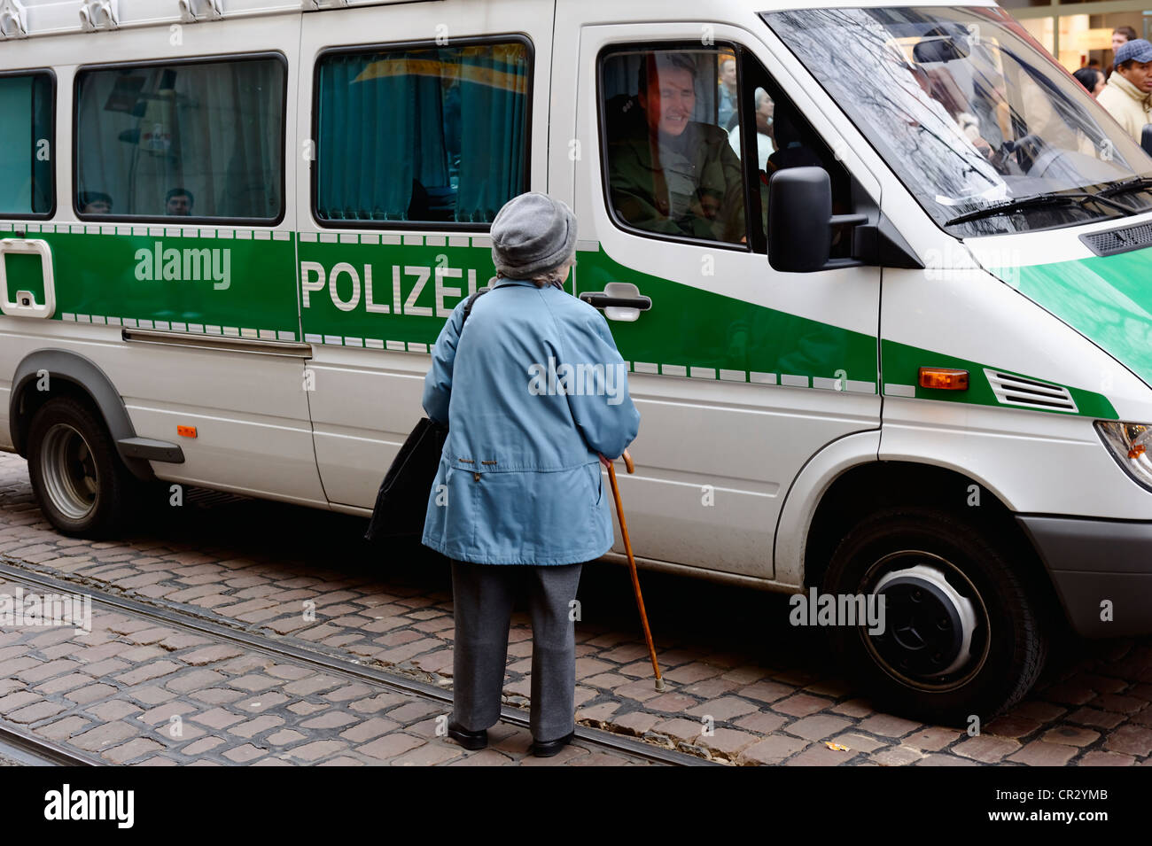 Femme âgée debout à côté d'une voiture de police, manifestation contre le sommet de l'OTAN en 2009, Freiburg, Bade-Wurtemberg Banque D'Images