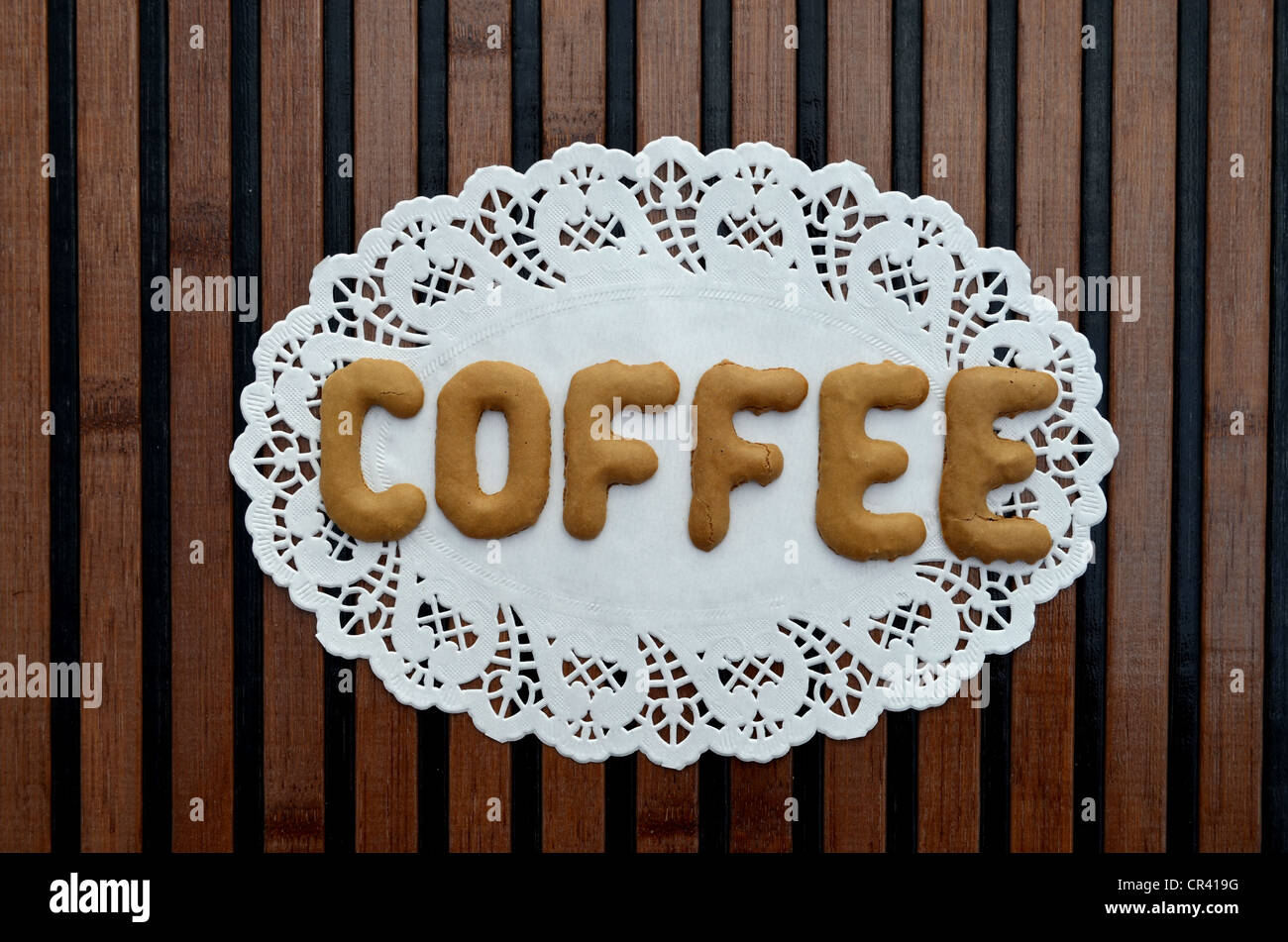 Le café, avec des biscuits alphabet écrites sur un papier napperon Banque D'Images