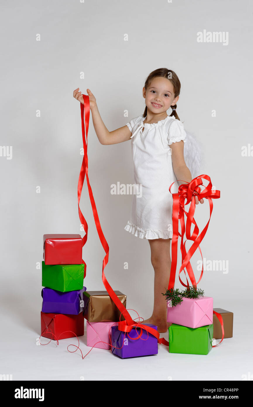 Fille habillé en ange de Noël avec les cadeaux de Noël, Banque D'Images