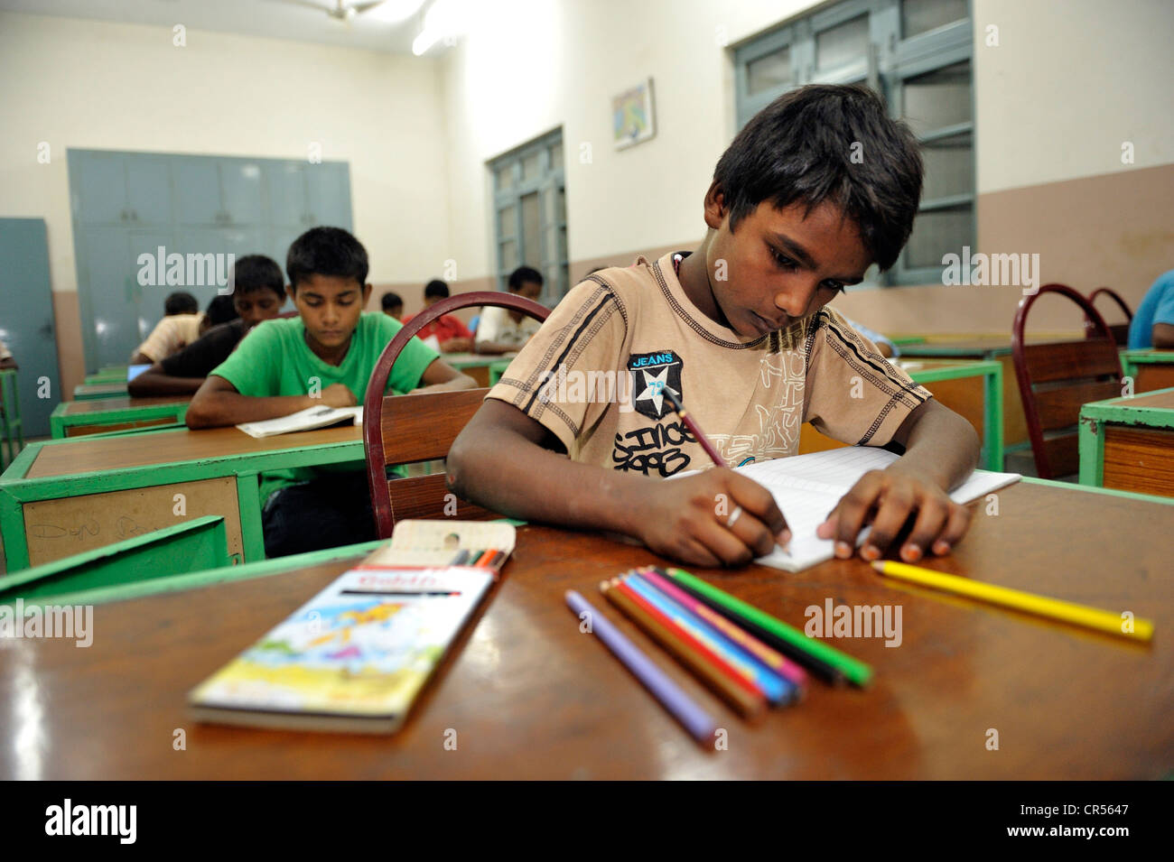Les élèves avec des crayons de couleur, de l'école l'enseignement dans une école intermédiaire, Youhanabad, Lahore, Punjab, Pakistan Banque D'Images